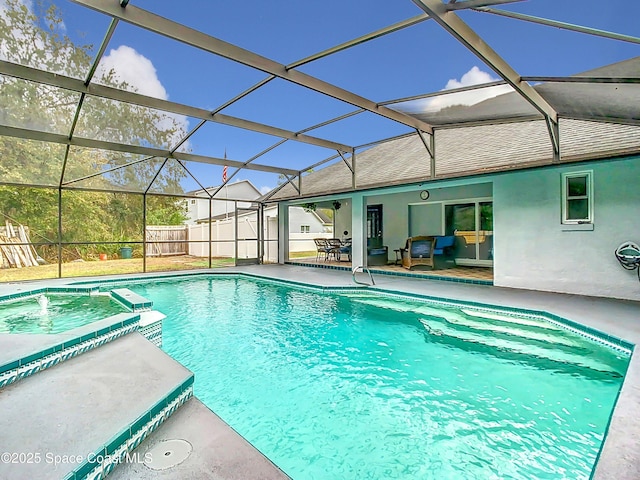 view of pool featuring glass enclosure, a patio area, and an in ground hot tub