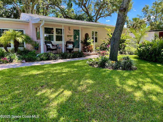 single story home with a front lawn and covered porch