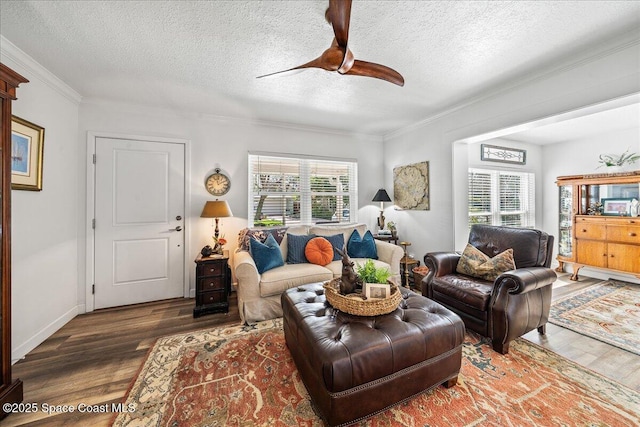 living room featuring crown molding, dark wood-type flooring, ceiling fan, and a textured ceiling