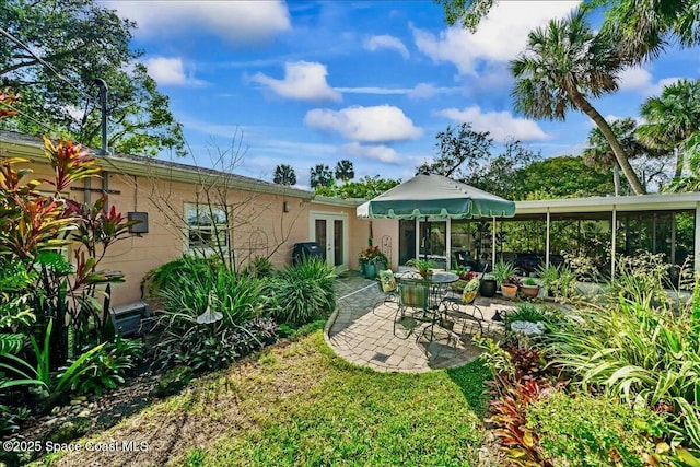 rear view of house featuring french doors and a patio area