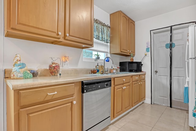 kitchen with light tile patterned floors, stainless steel dishwasher, white refrigerator, and sink