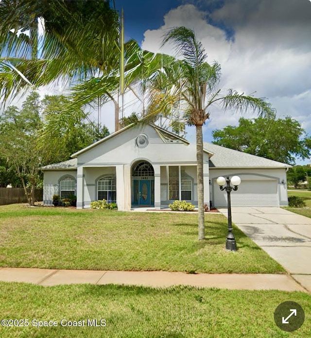 view of front of home with a garage and a front yard