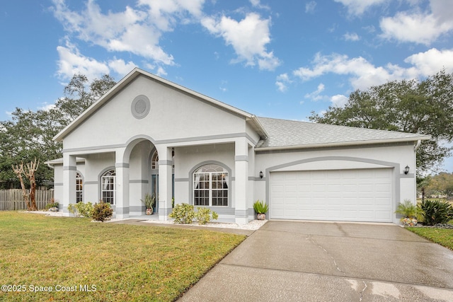 single story home with a garage and a front lawn