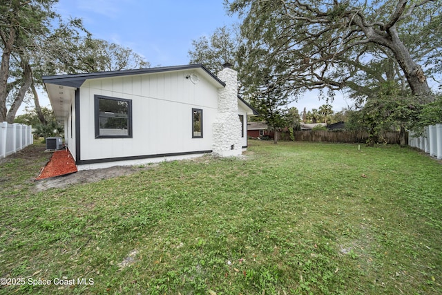 exterior space with a lawn and central air condition unit