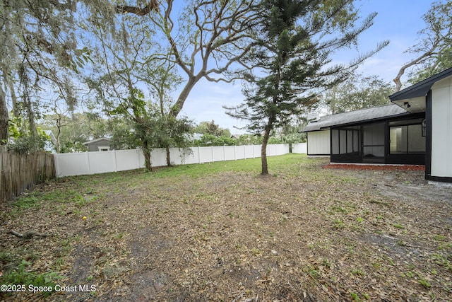 view of yard featuring a sunroom