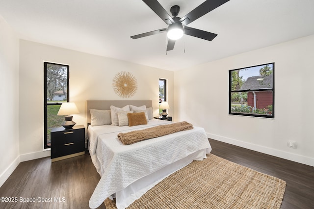 bedroom with ceiling fan and dark hardwood / wood-style flooring