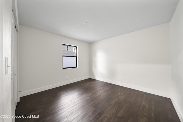 spare room featuring dark hardwood / wood-style floors