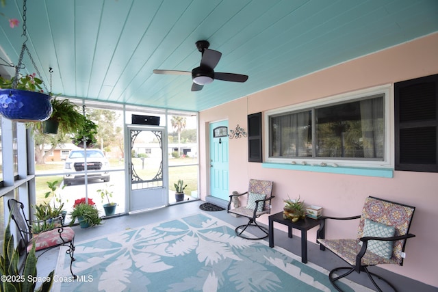 sunroom / solarium featuring ceiling fan