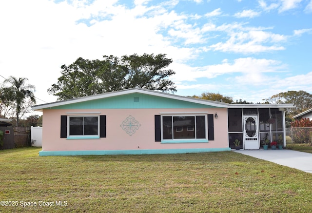 single story home featuring a front lawn and a sunroom