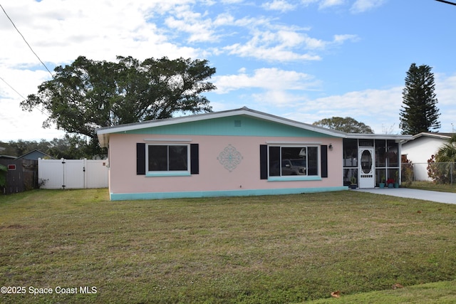 single story home with a front lawn and a sunroom