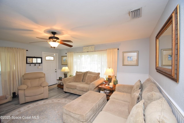 living room with ceiling fan and light hardwood / wood-style floors