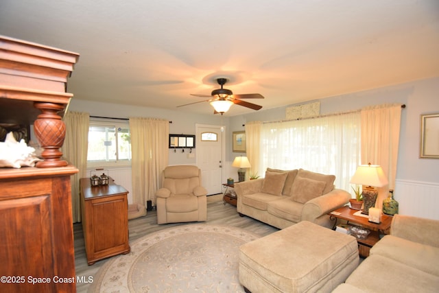 living room with ceiling fan and light hardwood / wood-style floors