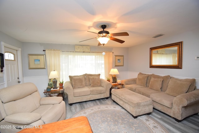 living room featuring ceiling fan and wood-type flooring