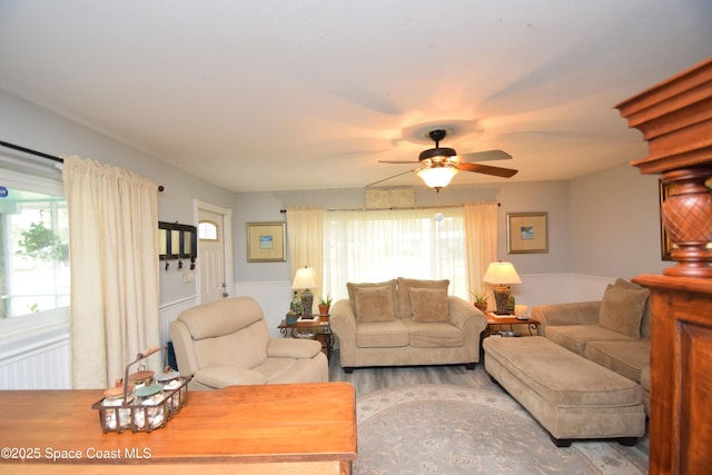 living room featuring ceiling fan and hardwood / wood-style flooring