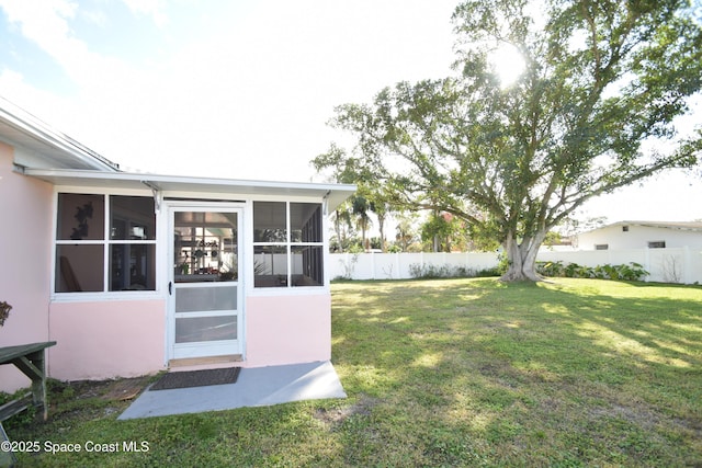 view of yard featuring a sunroom