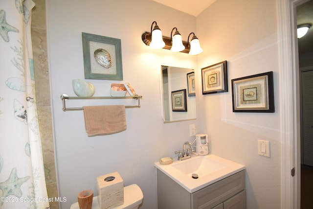 bathroom featuring toilet and vanity