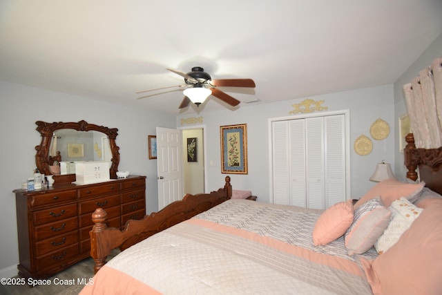 bedroom with ceiling fan and a closet