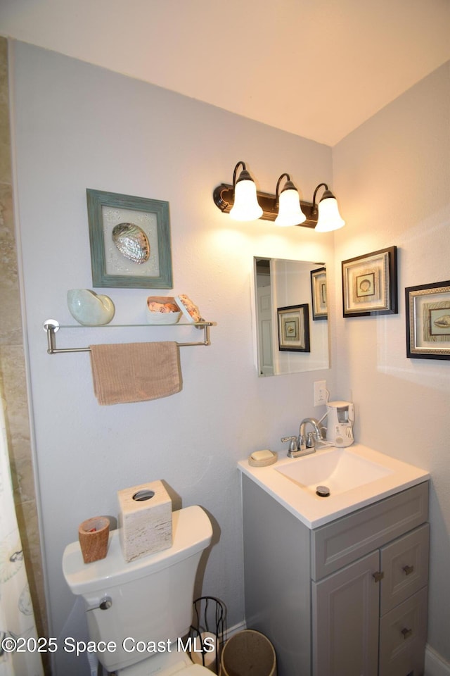 bathroom with toilet and vanity