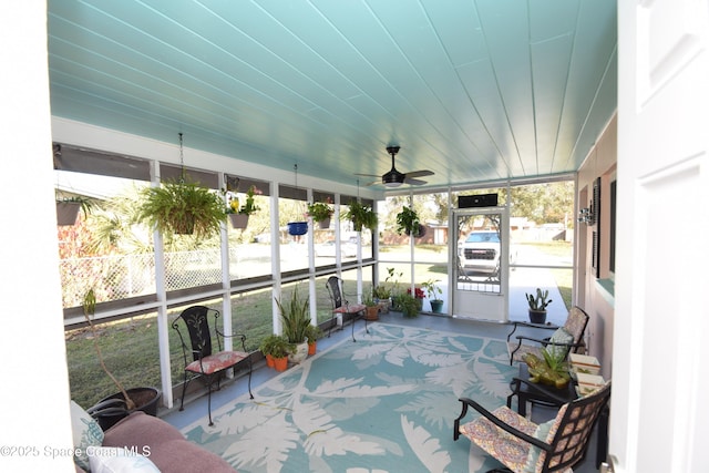 sunroom / solarium featuring ceiling fan