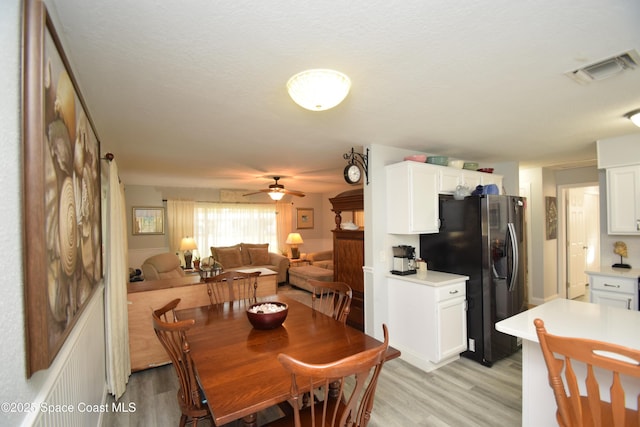 dining room featuring ceiling fan and light wood-type flooring