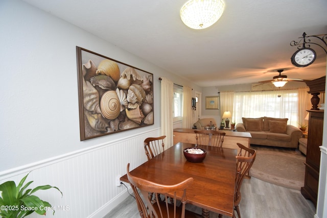 dining room with ceiling fan and light wood-type flooring