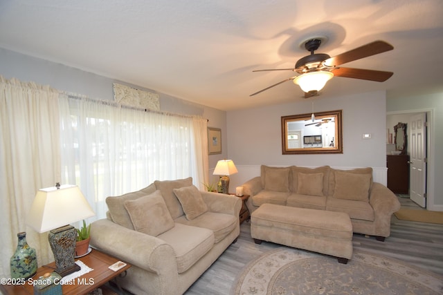 living room featuring ceiling fan and hardwood / wood-style flooring