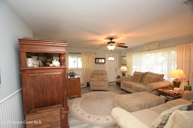 living room with ceiling fan and hardwood / wood-style floors