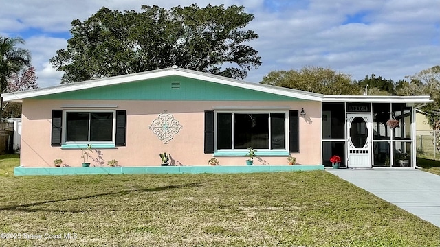 rear view of house with a lawn