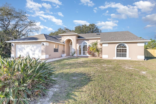 view of front of house with a front yard, a garage, and french doors