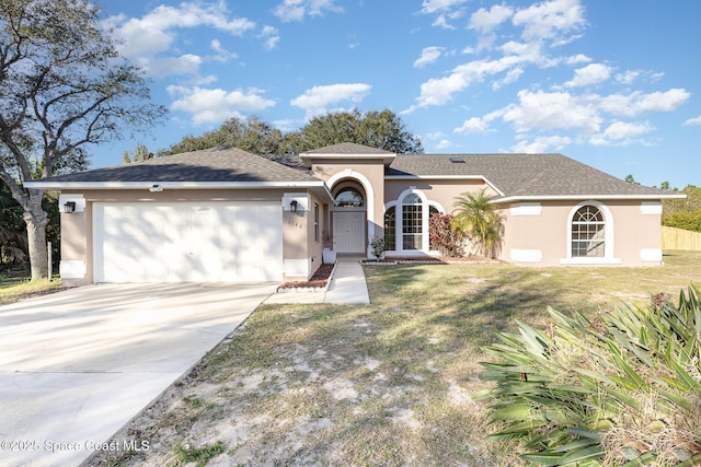 ranch-style house with a garage and a front lawn