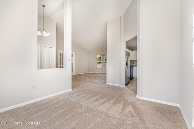 interior space with high vaulted ceiling and an inviting chandelier