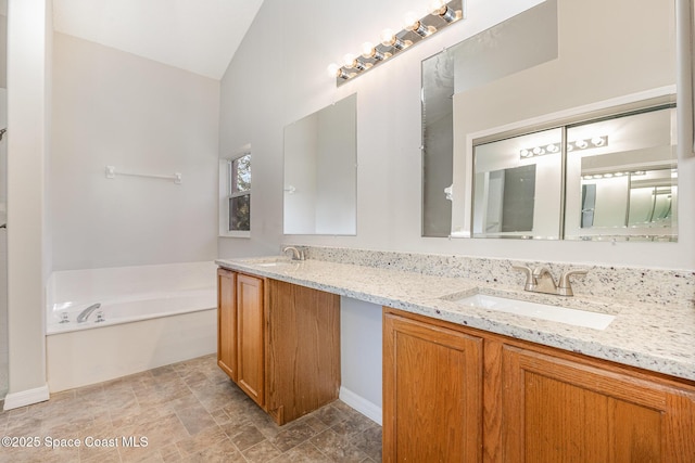 bathroom with vanity and a tub