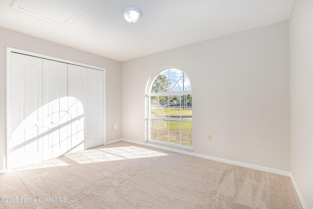 unfurnished room with light carpet