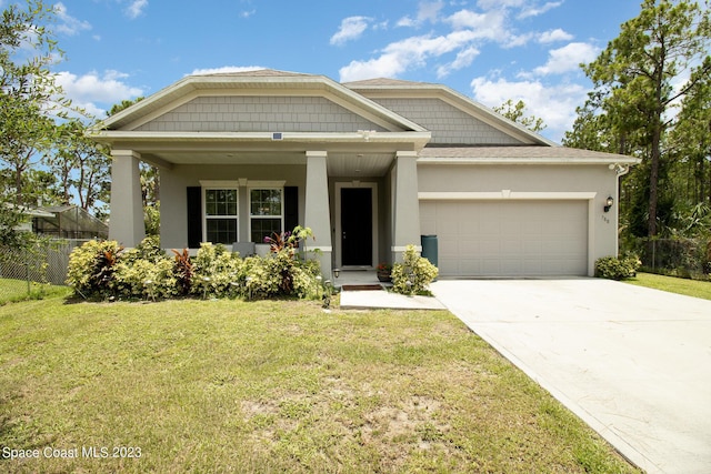 view of front of house with a front yard and a garage