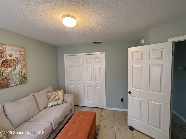 tiled living room with a textured ceiling