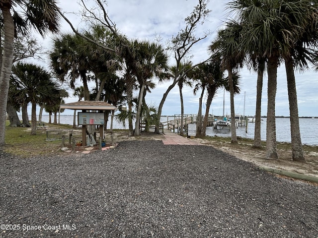 view of yard featuring a boat dock and a water view