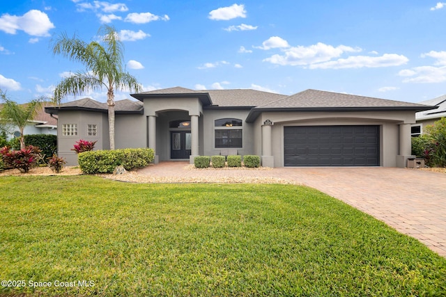 view of front of home with a garage and a front yard