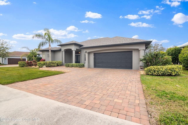 view of front of property featuring a garage and a front lawn