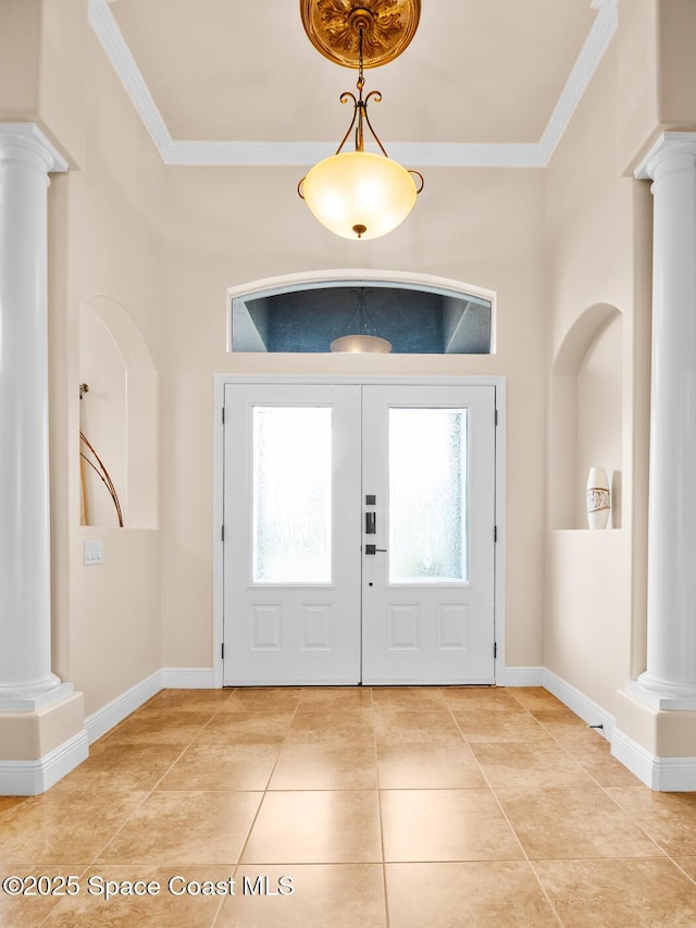 tiled foyer featuring ornamental molding