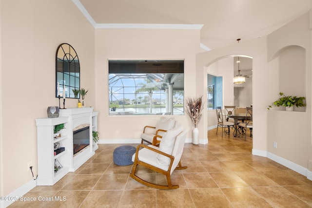 living area featuring crown molding and light tile patterned floors