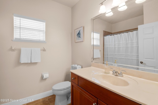 bathroom featuring tile patterned floors, toilet, and vanity