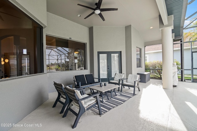 view of patio with an outdoor hangout area, ceiling fan, and glass enclosure