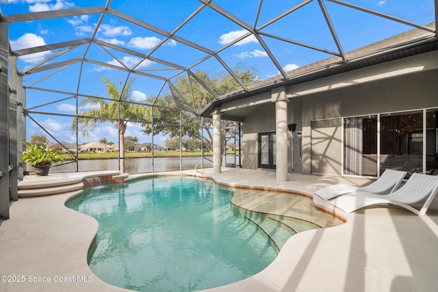 view of pool featuring a patio, a water view, and glass enclosure