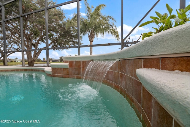 view of swimming pool with pool water feature