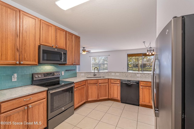 kitchen with appliances with stainless steel finishes, sink, backsplash, ceiling fan, and light tile patterned floors