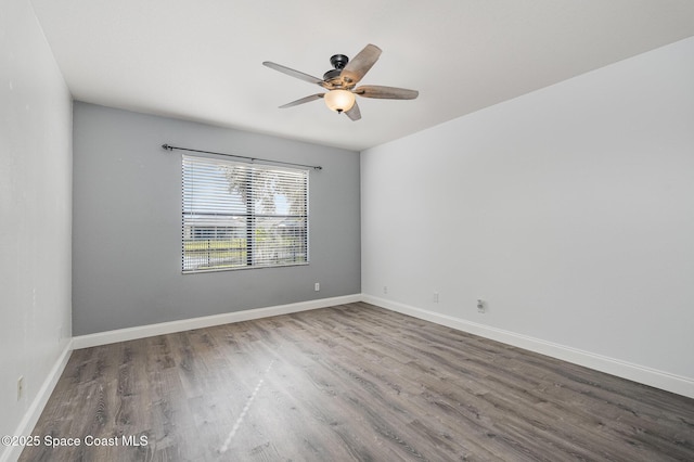 empty room with ceiling fan and hardwood / wood-style floors