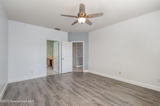 unfurnished bedroom with ceiling fan, light hardwood / wood-style floors, and ensuite bath