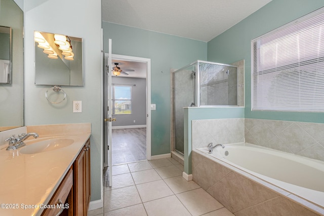 bathroom featuring ceiling fan, vanity, tile patterned floors, and shower with separate bathtub