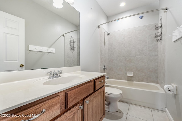 full bathroom featuring toilet, vanity, tiled shower / bath combo, and tile patterned floors