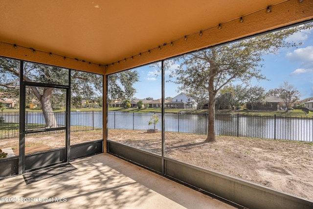 unfurnished sunroom with a water view